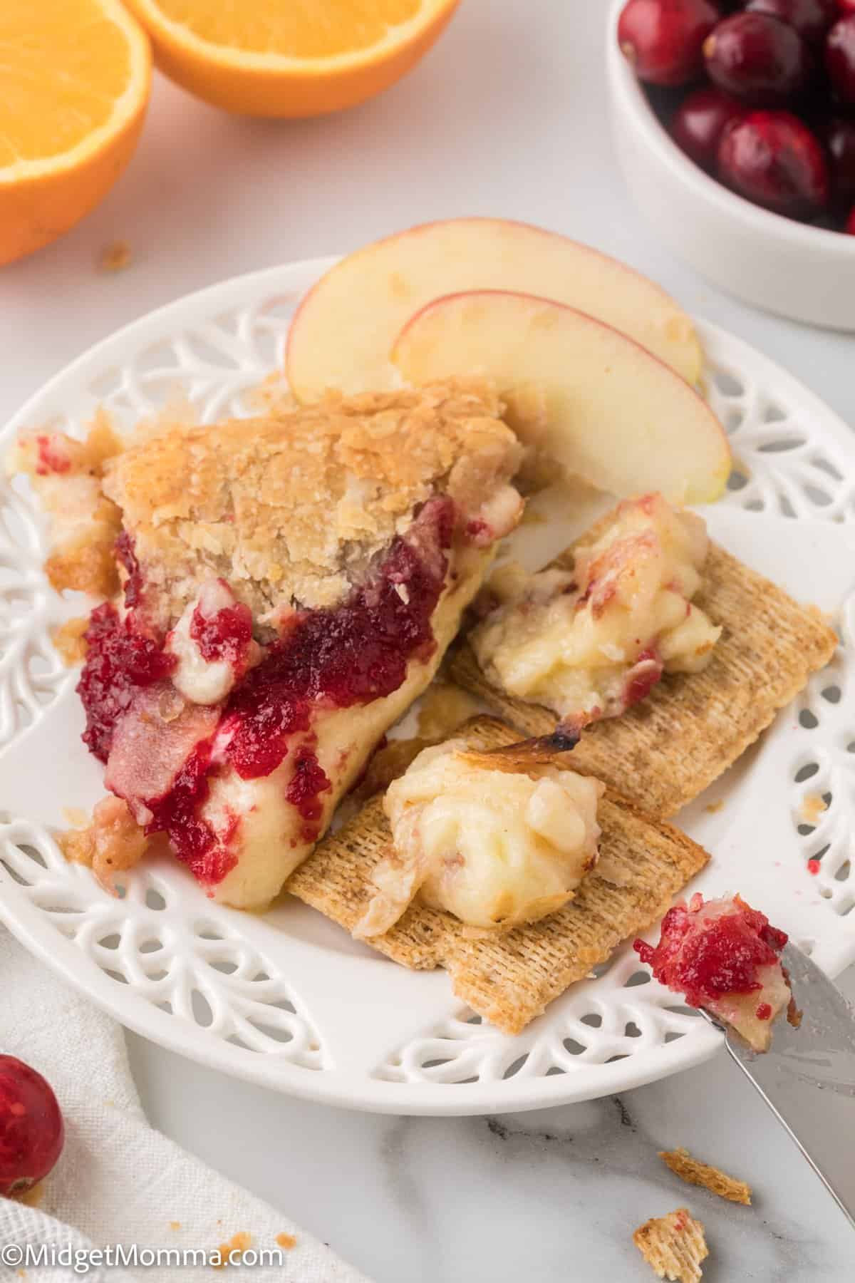 Cranberry Baked Brie on a plate with crackers