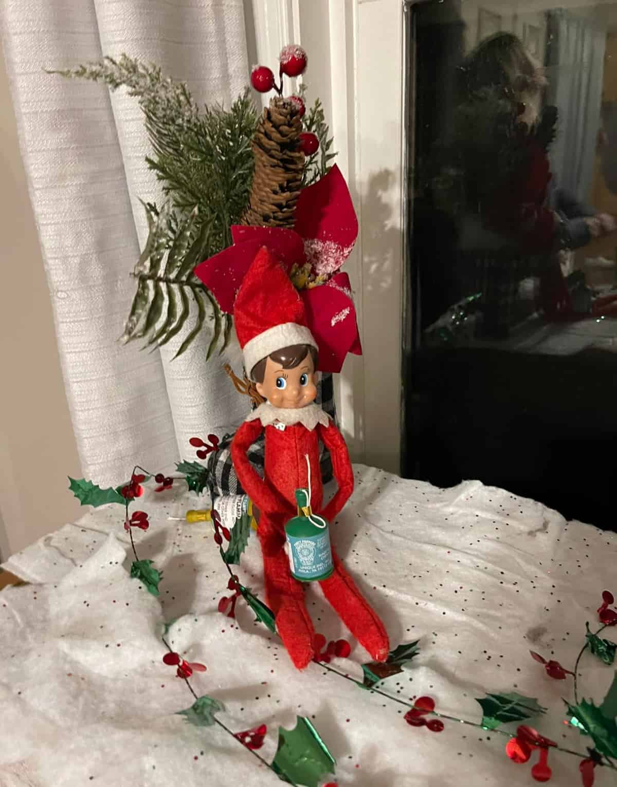 elf plays with Christmas decorations