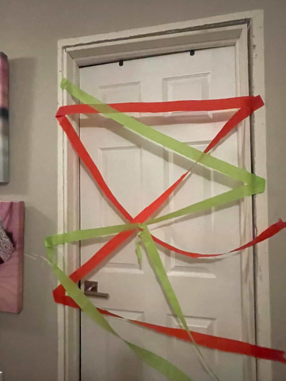 elf traps kids in the bedroom with paper streamers