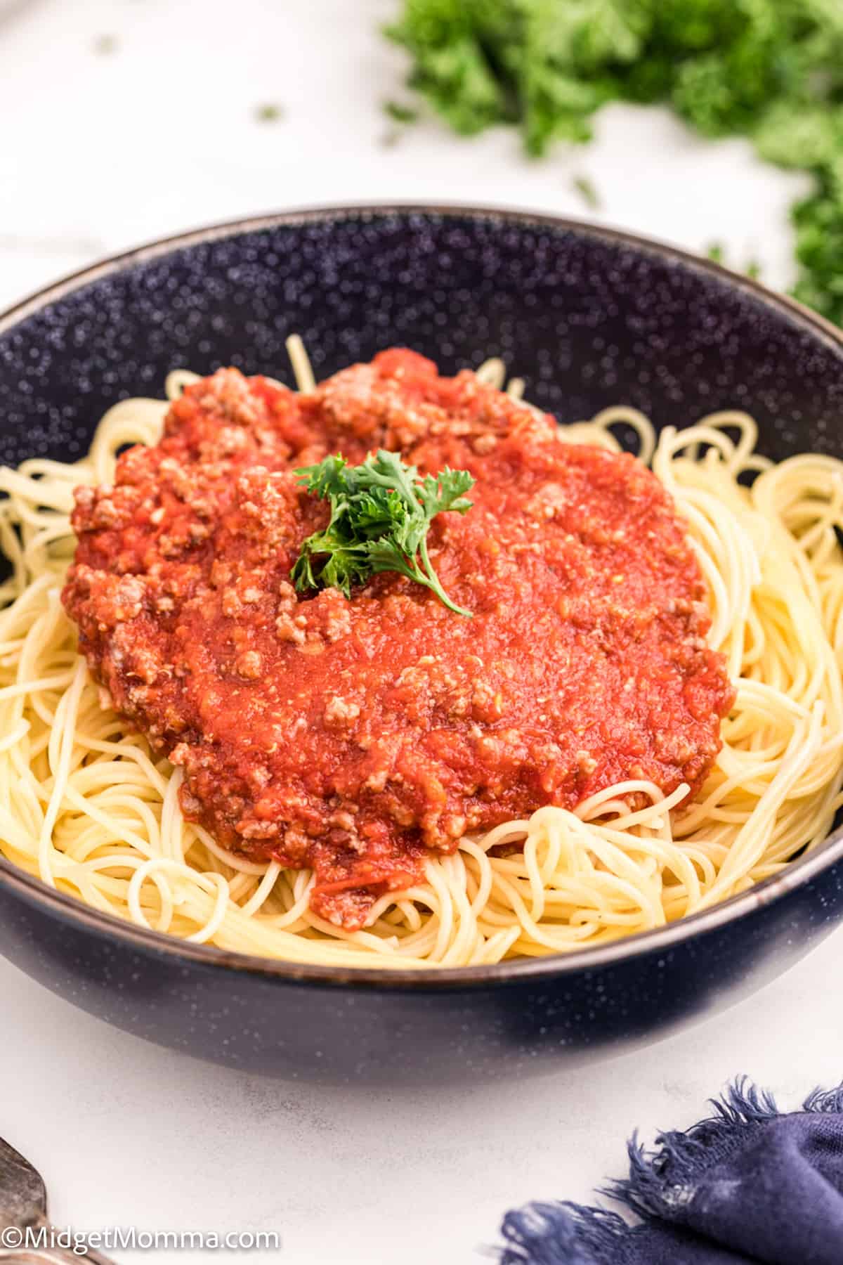 Spaghetti Meat Sauce  on top of cooked spaghetti noodles in a bowl