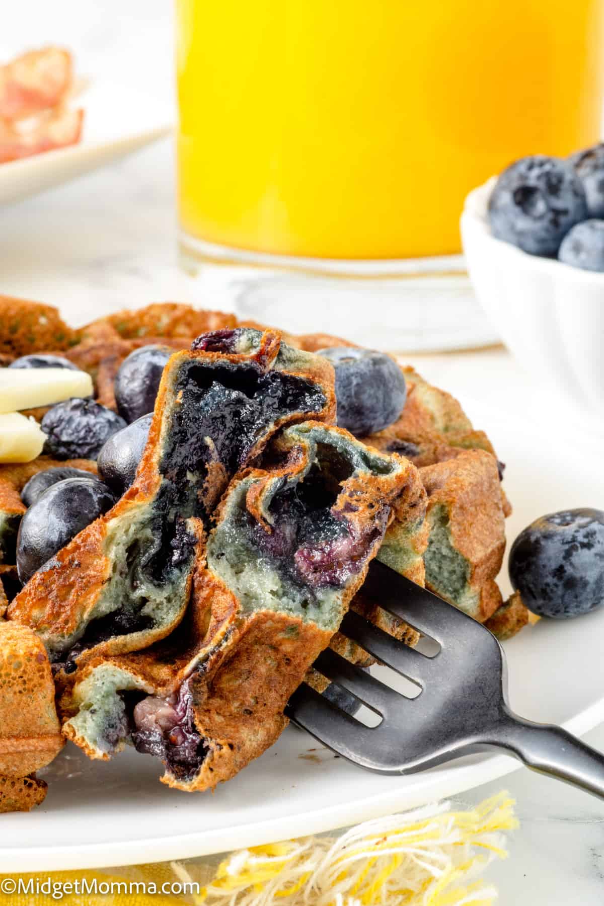 fork full of blueberry waffles