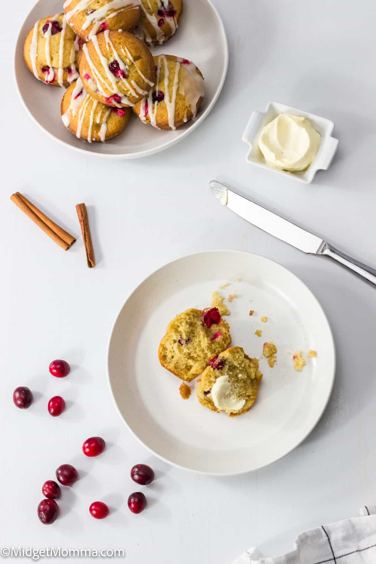 Cranberry Orange Muffin with butter on a plate