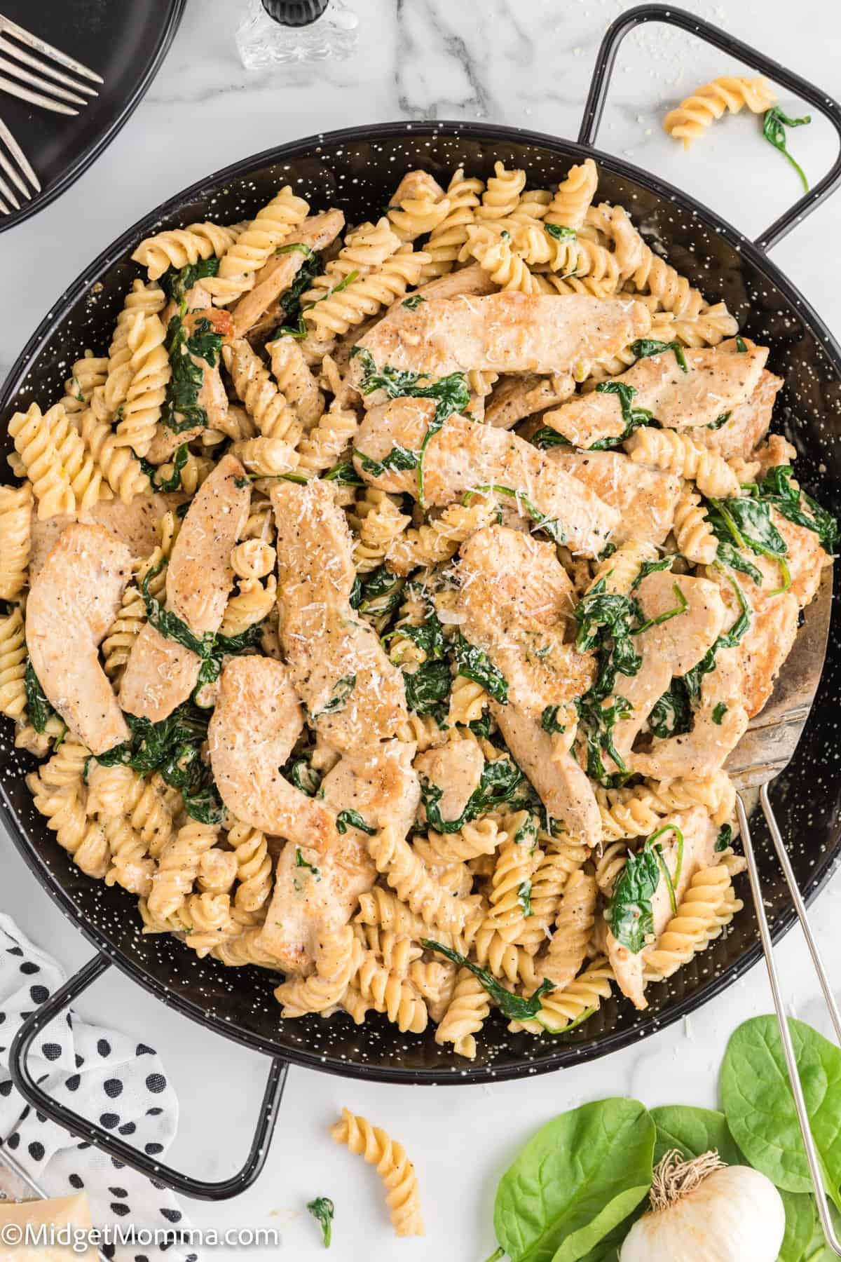 overhead photo of creamy garlic chicken pasta in a serving dish