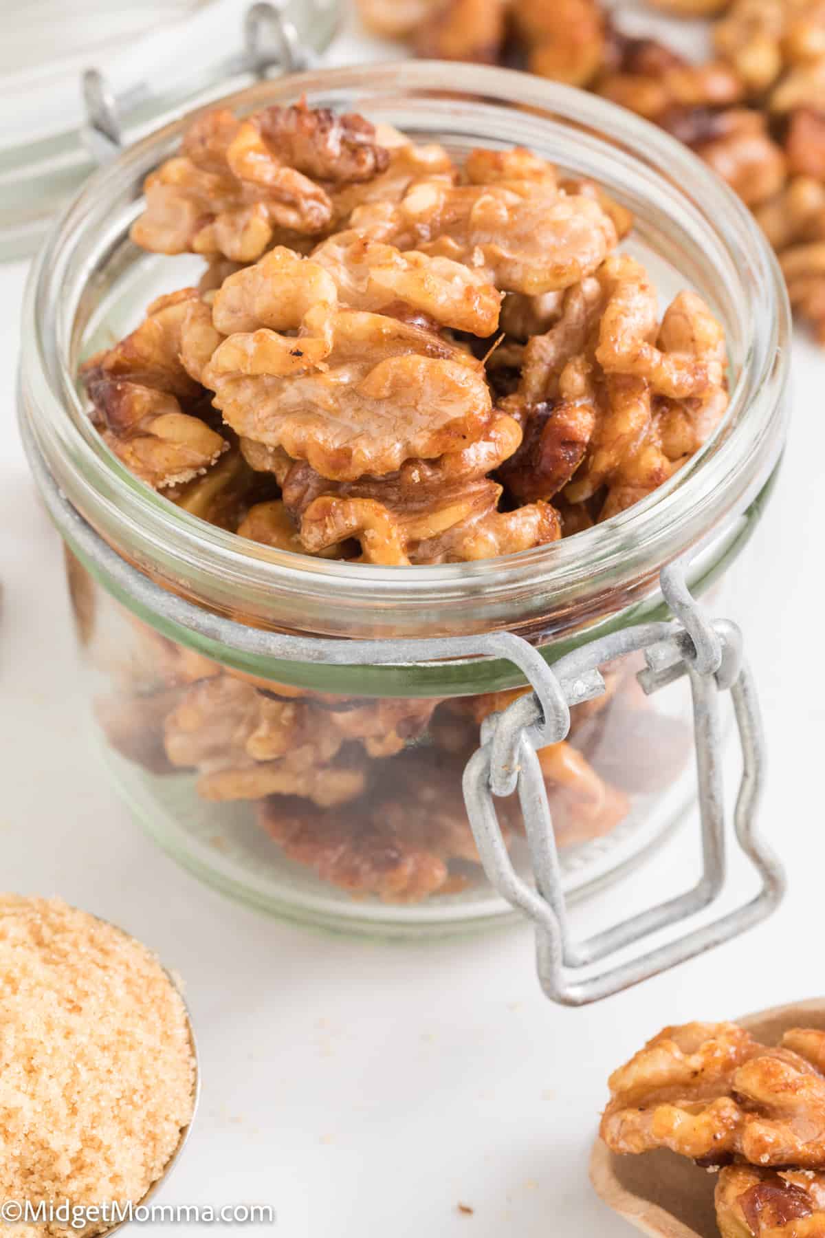 side view of a jar of nuts coated in brown sugar
