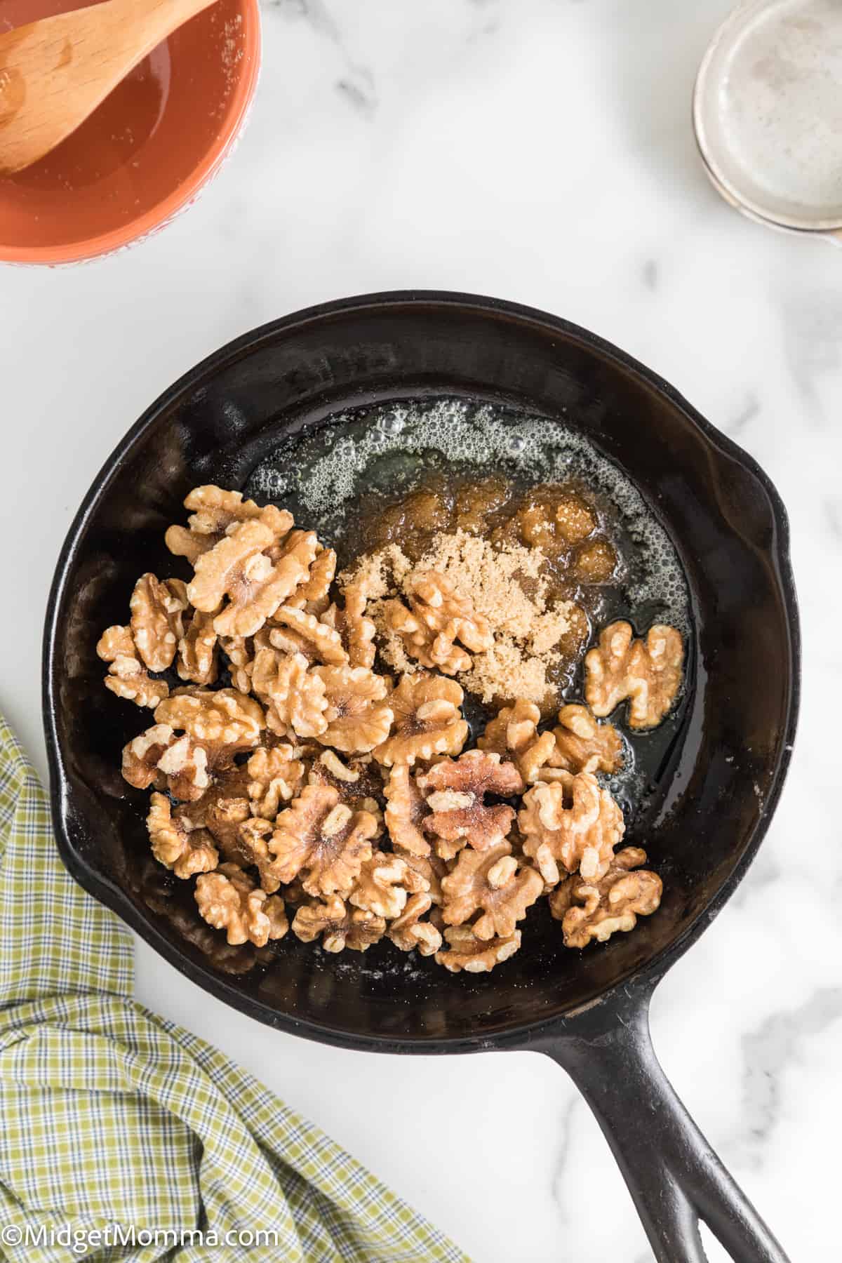 nuts and brown sugar in a pan with melted butter 
