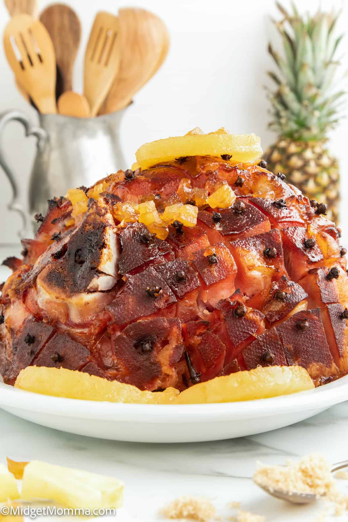 close up photo of Baked Ham with Pineapple and Brown Sugar Glaze uncut on a plate