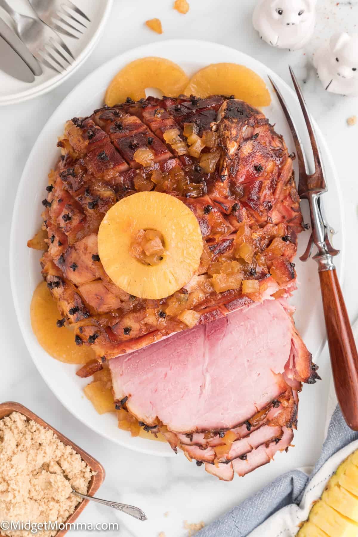 over head photo of baked ham with brown sugar glaze on a serving platter
