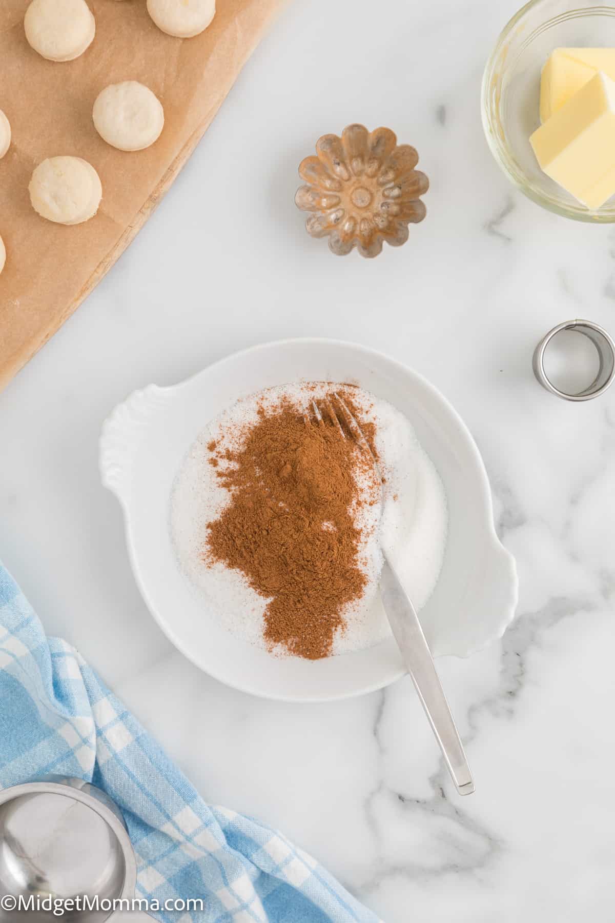 cinnamon and sugar being mixed in a bowl