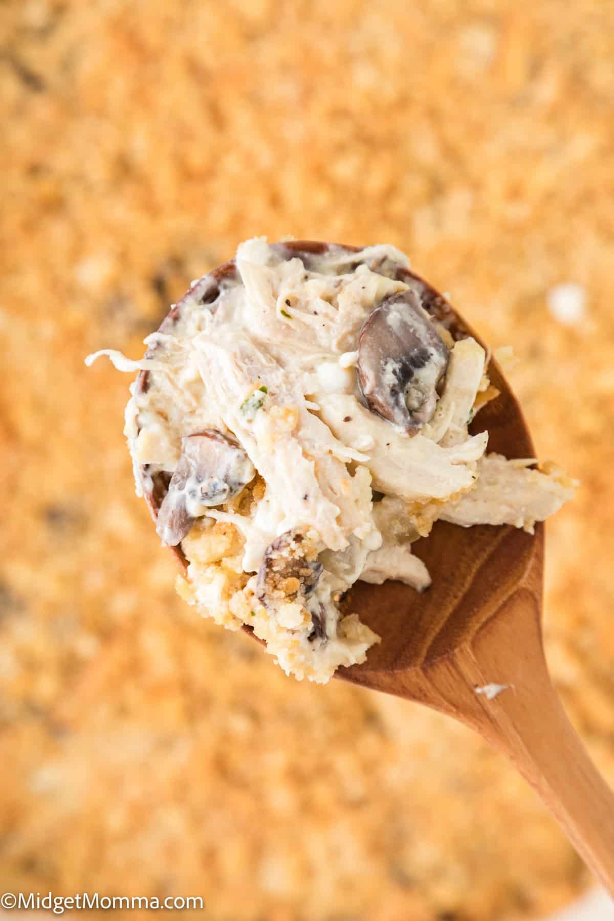 serving spoon with Creamy Million Dollar Chicken Casserole being scooped out of casserole dish