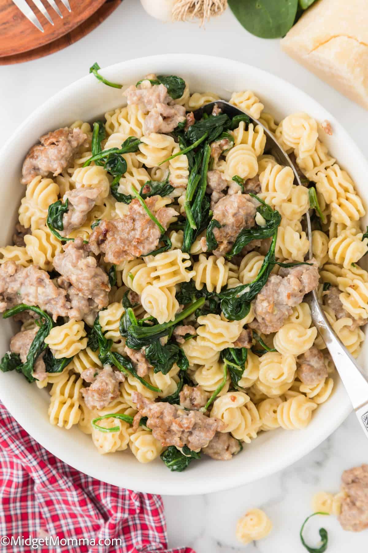 overhead photo of Creamy Spinach Sausage Pasta in a white bowl