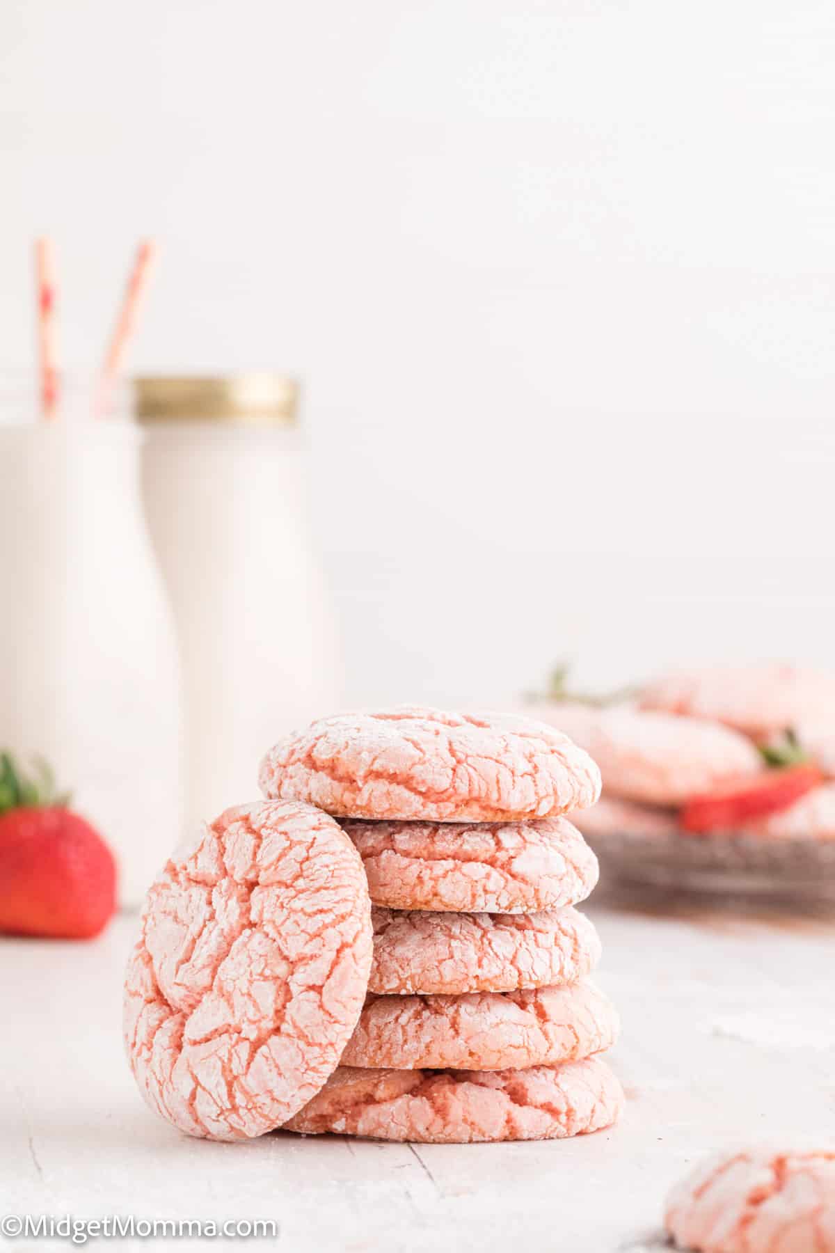 stack of. Strawberry Cake Mix Cookies with 2 glasses of milk in the background