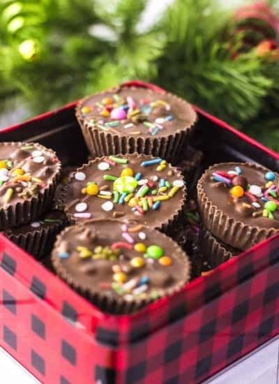 close up photo of Crockpot Christmas Candy in a christmas tin