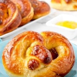 close up photo of a homemade soft pretzel on a plate