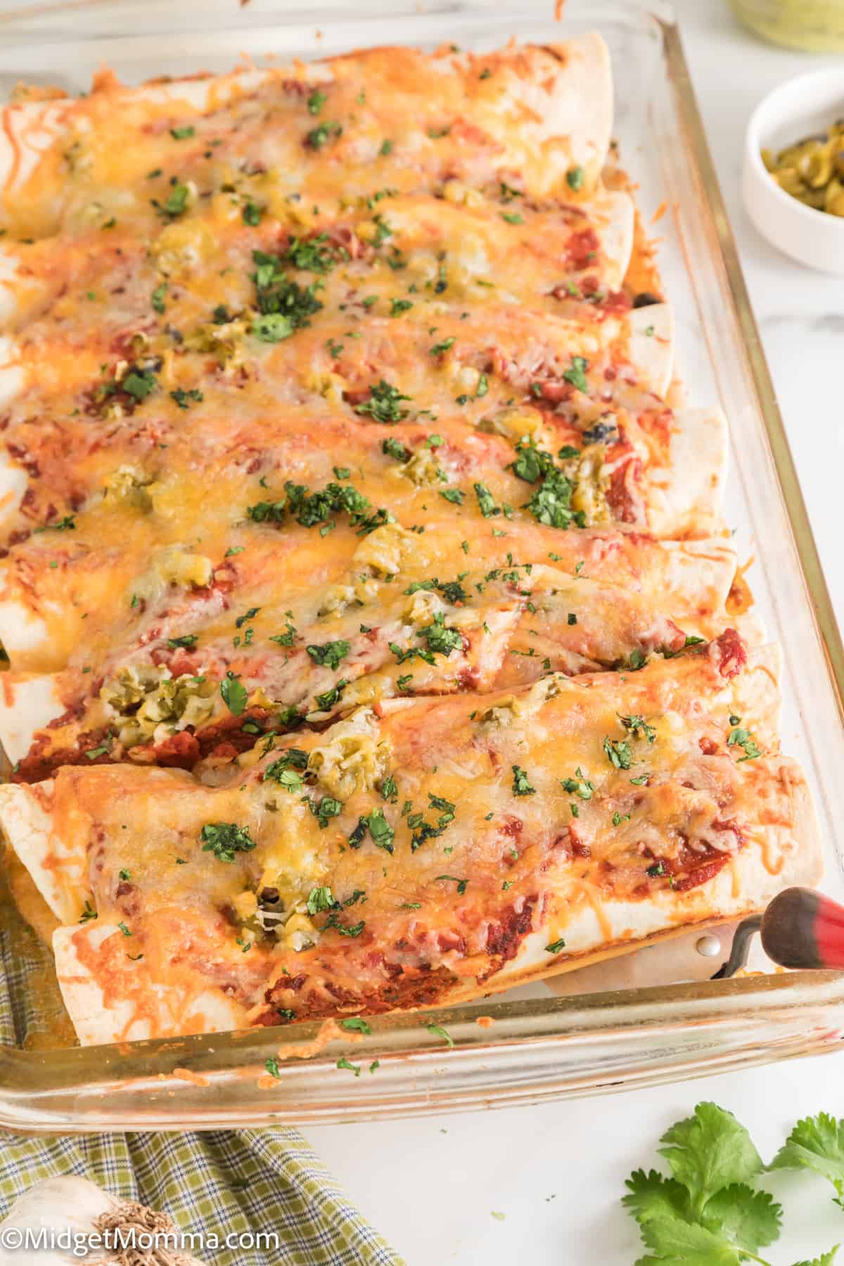 close up photo of Cheesy Baked Beef Enchiladas in a casserole dish