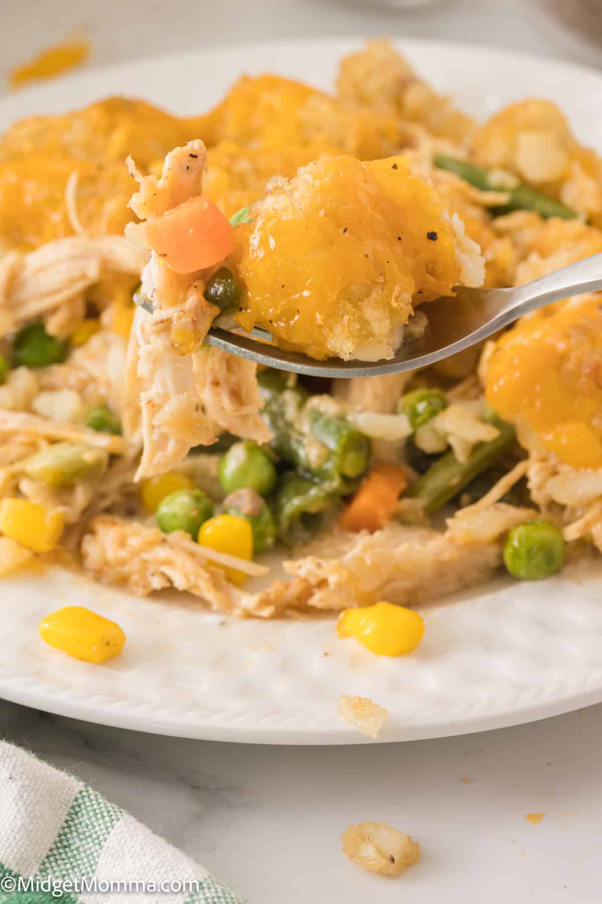 close up photo of a fork full of Cheesy Chicken Tater Tot Casserole 