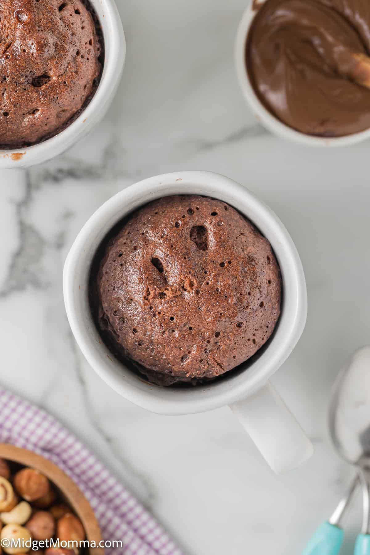 overhead photo of Nutella Mug Cake in a white mug right out of the microwave