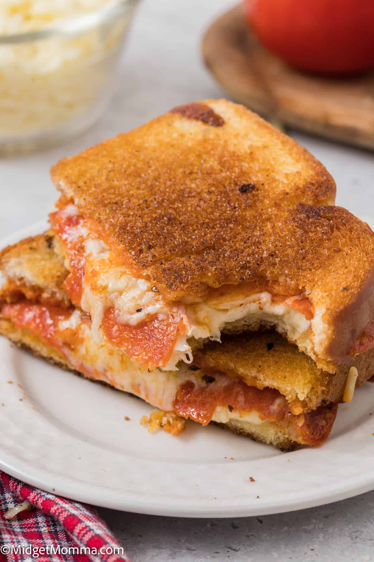 Pizza Grilled Cheese Sandwich Recipe with a bite out of a sandwich