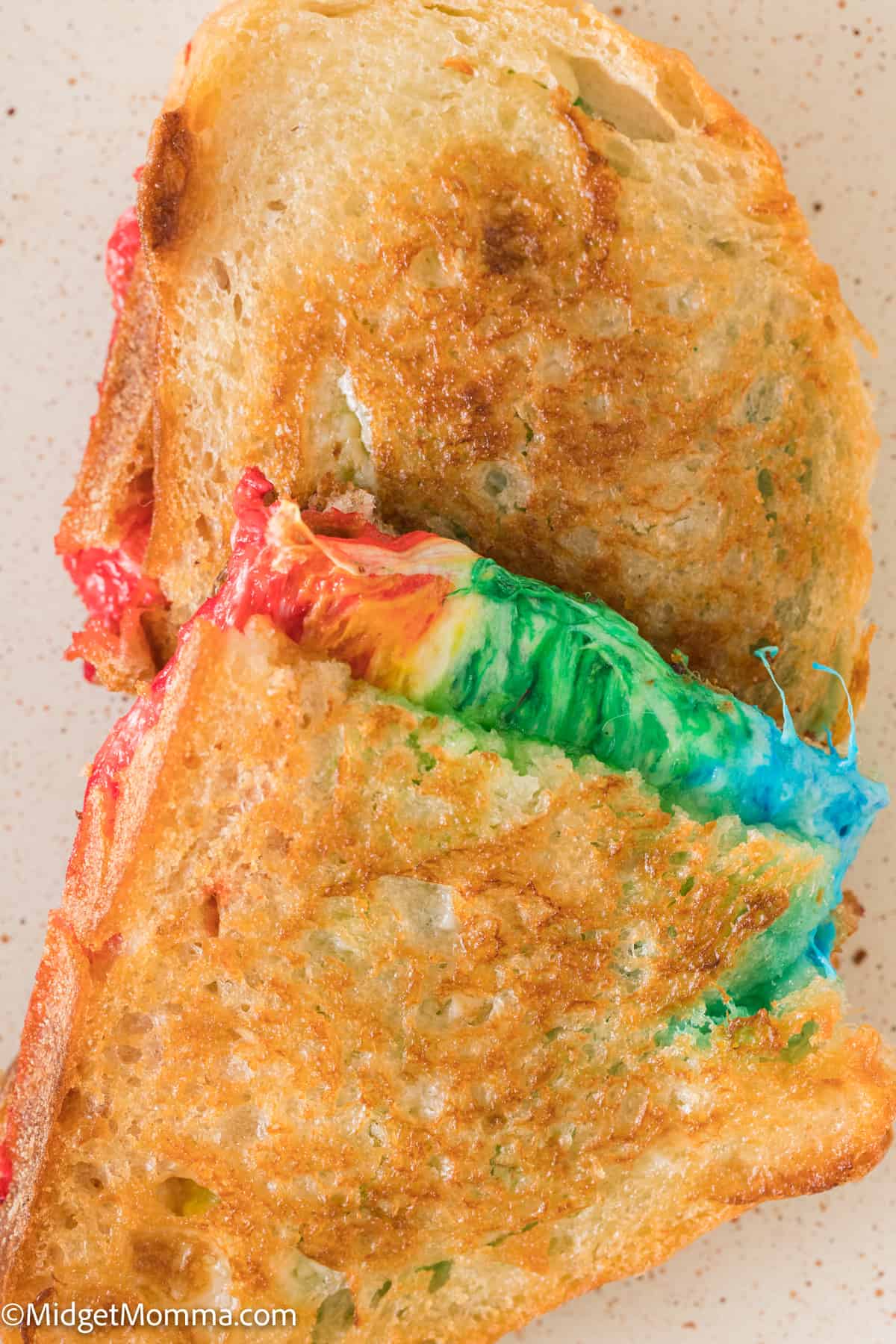 close up overhead photo of Rainbow Grilled Cheese Sandwich on a white plate.