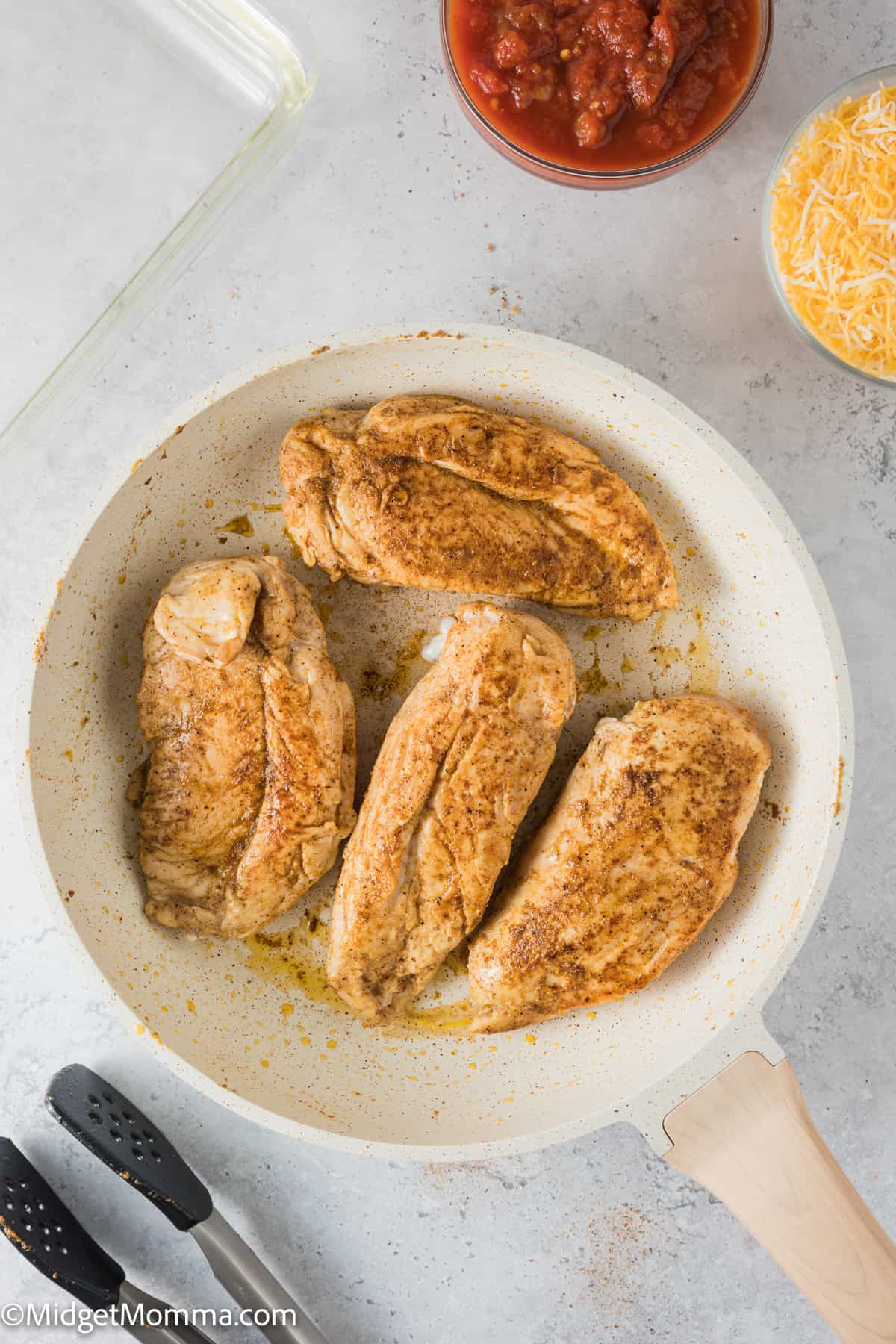 chicken breasts cooking in a skillet