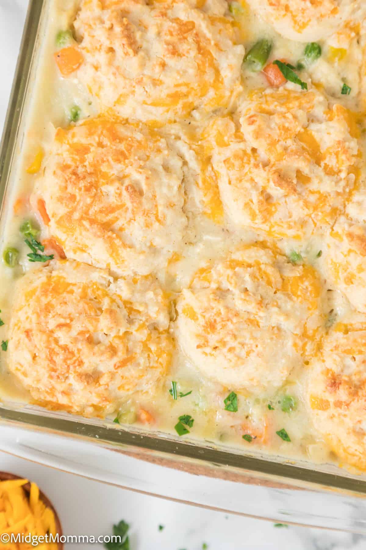 close up photo of Easy Chicken Pot Pie Casserole with Cheddar Drop Biscuit Topping in a baking dish