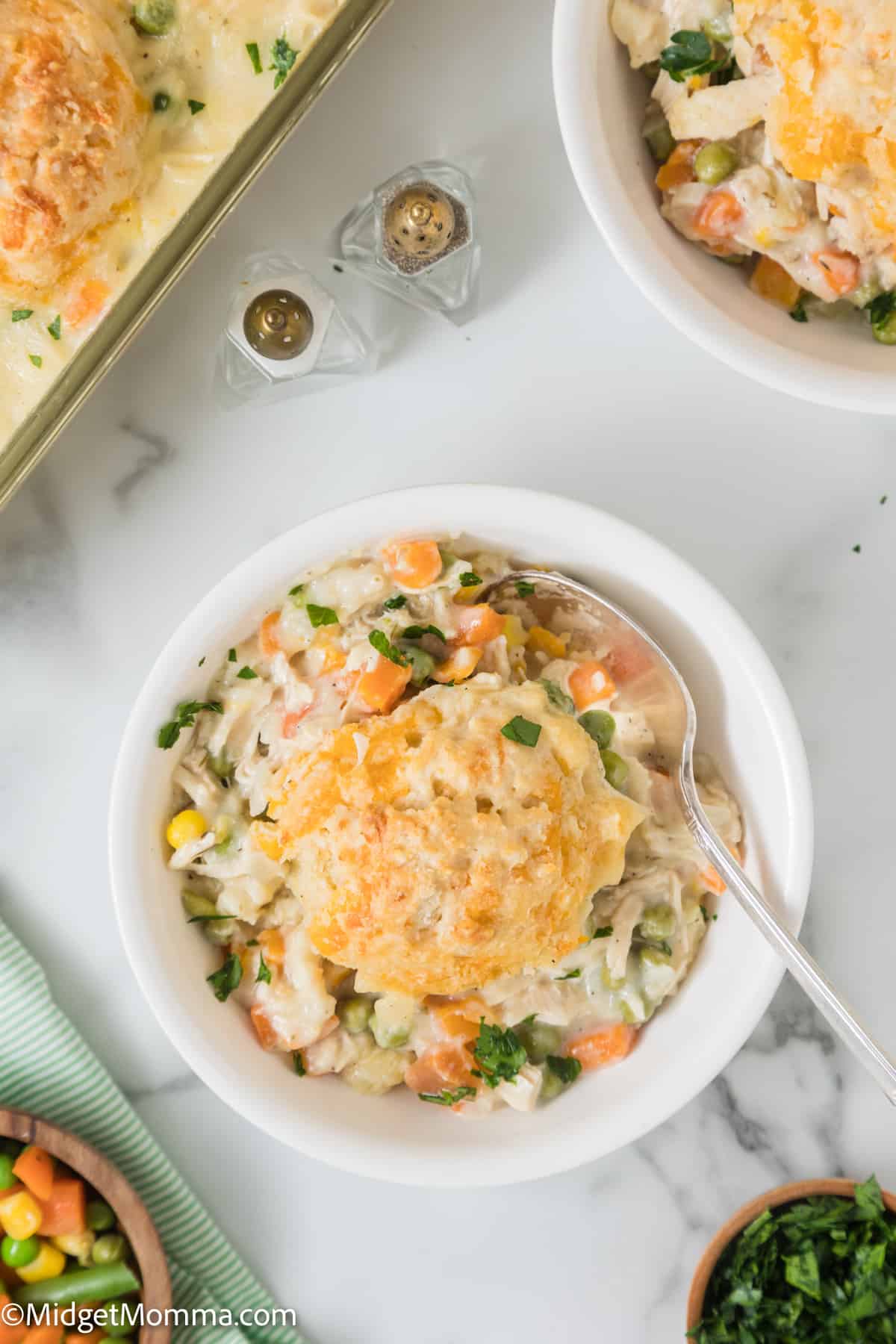 bowl of Easy Chicken Pot Pie Casserole with the full casserole dish in the background