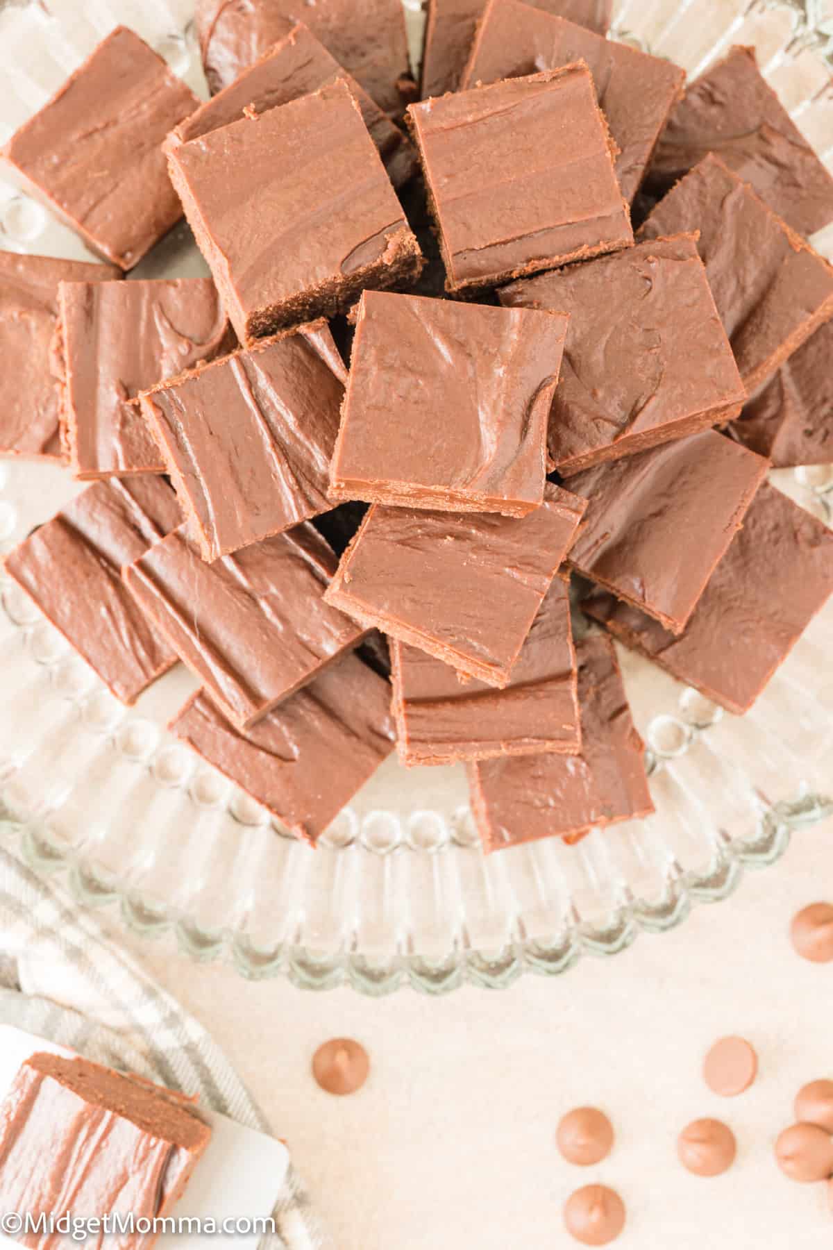 overhead photo of 2 ingredient fudge made with chocolate frosting and chocolate chips on a glass serving platter