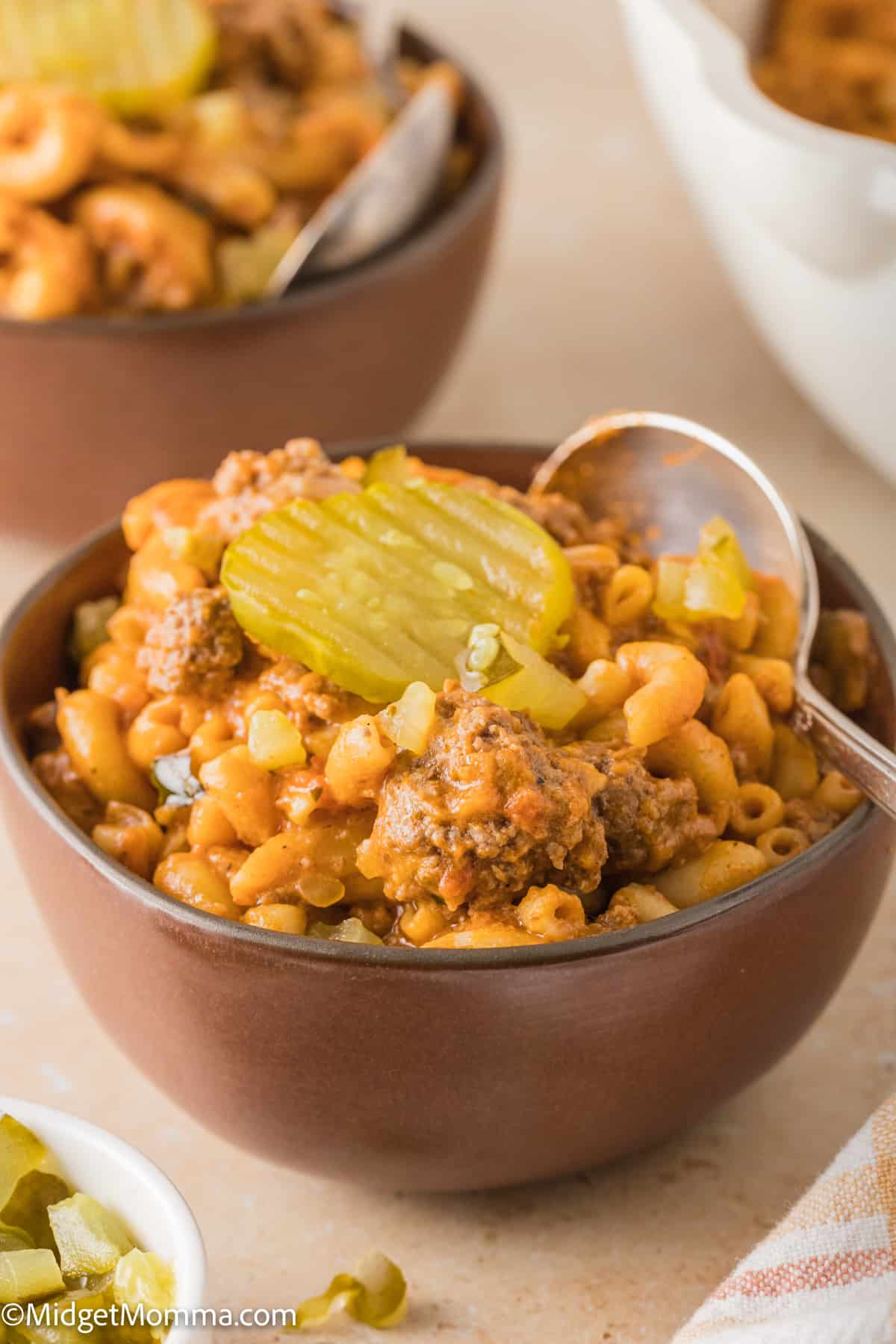 bowl of Homemade Hamburger Helper cheeseburger pasta topped with a pickle slice