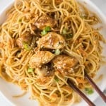 overhead photo of Thai Peanut Noodles with Chicken on a white plate with chopsticks