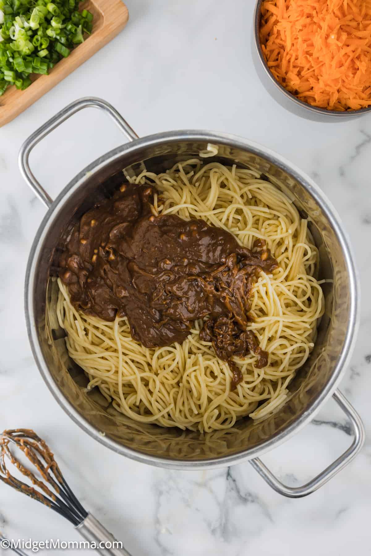 cooked noodles in a pot with peanut sauce