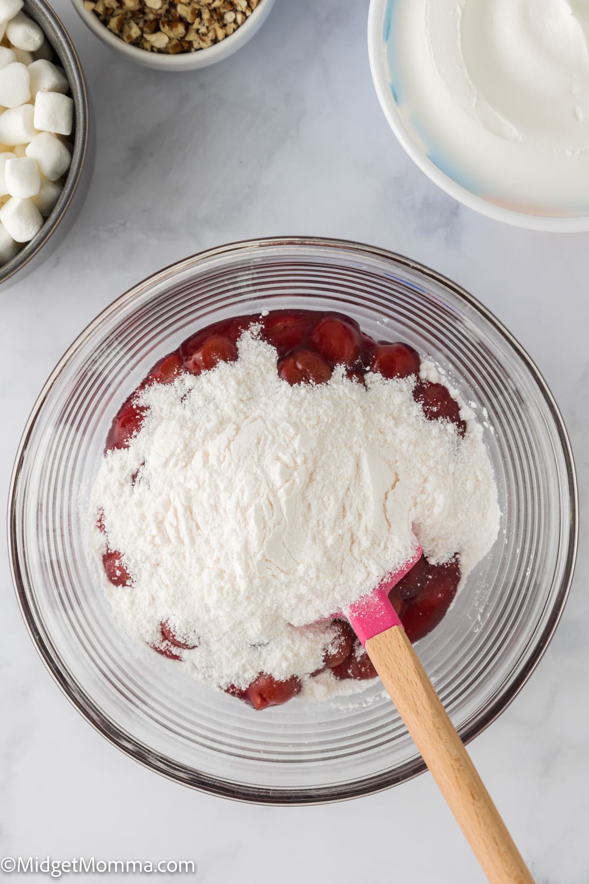cherry pie filling and vanilla instant pudding mixed in a large mixing bowl