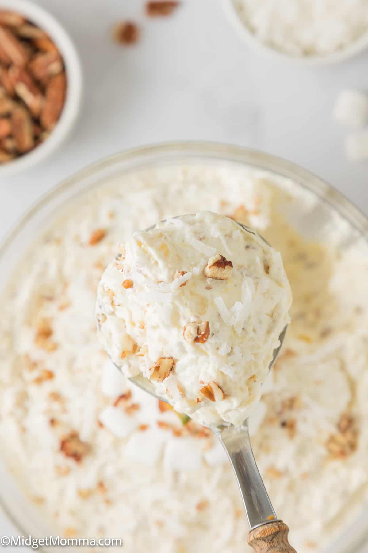 large spoon full of pine apple fluff salad 