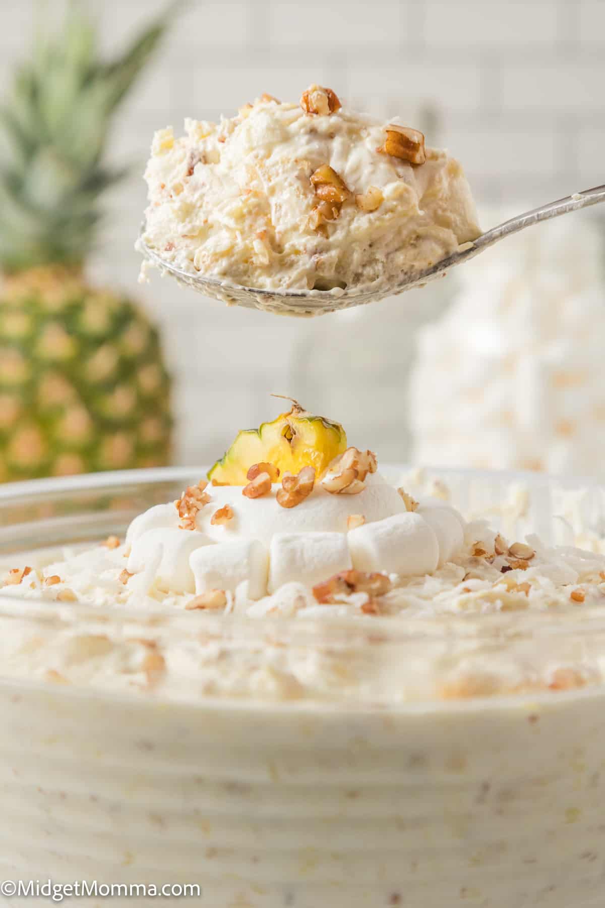 Pineapple fluff recipe being scooped from the serving dish