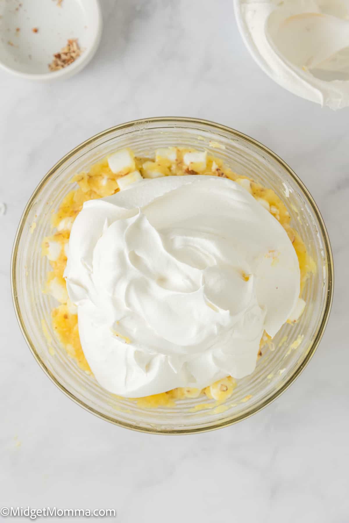 cool whip being added into the Pineapple fluff recipe mixture 