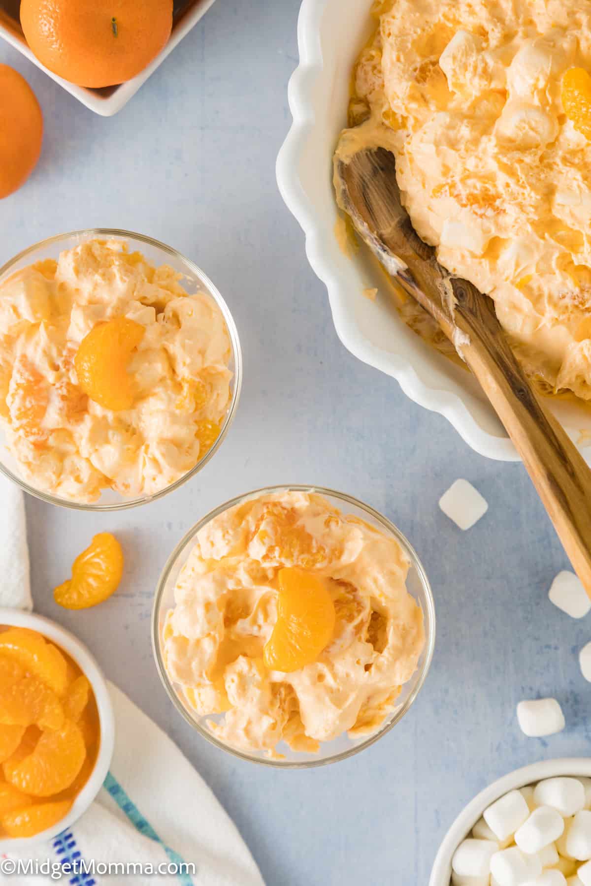 2 small bowls of orange fluff salad being served