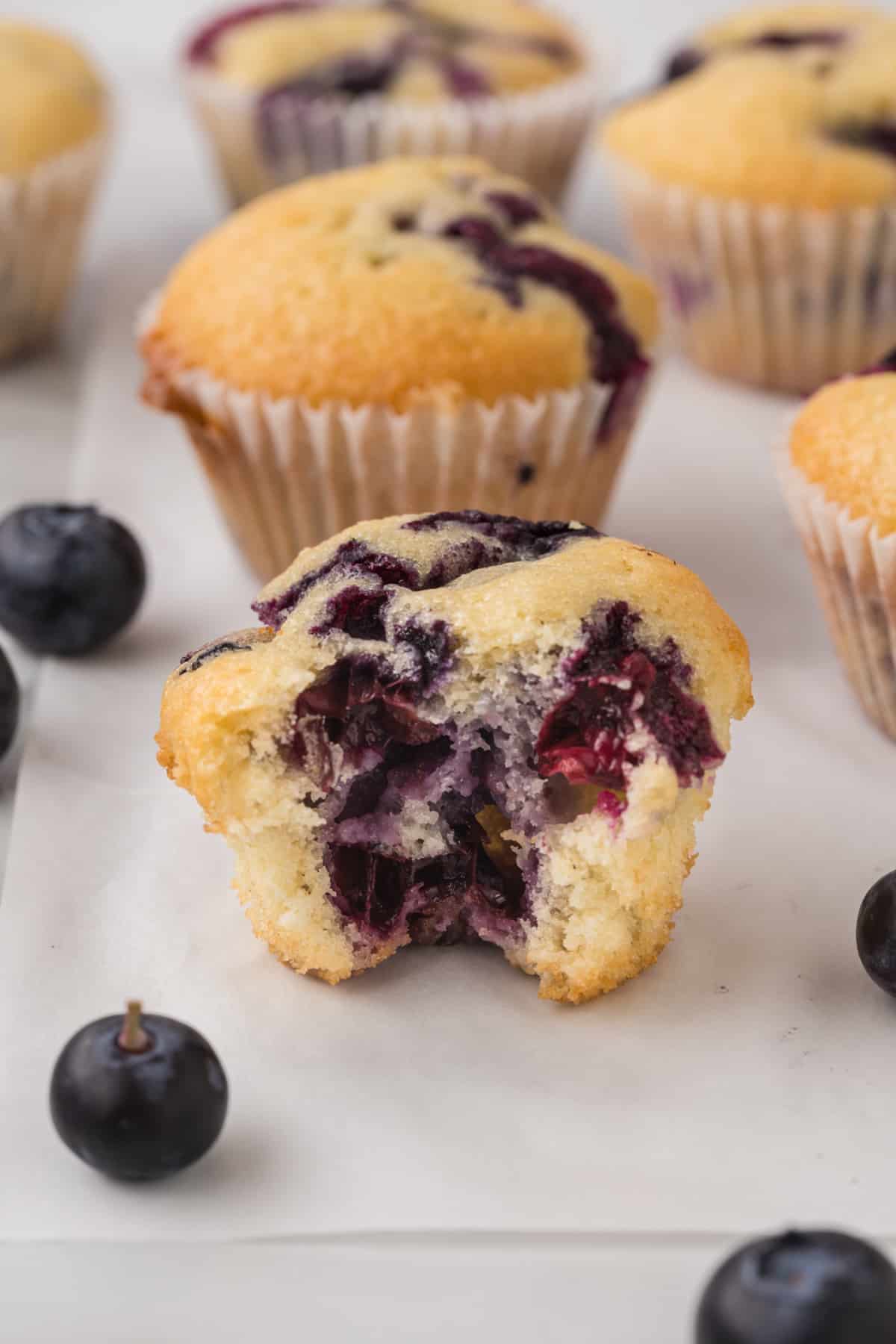 mini Blueberry muffin with a bite taken out of it.