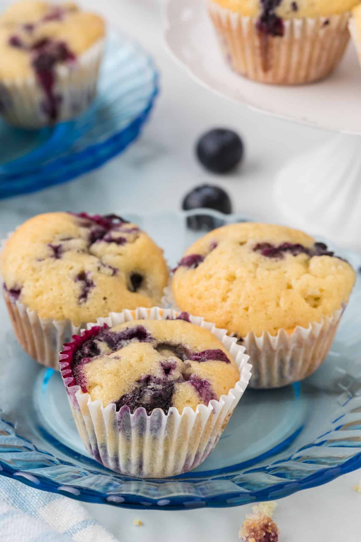 Blueberry muffins on a blue plate.