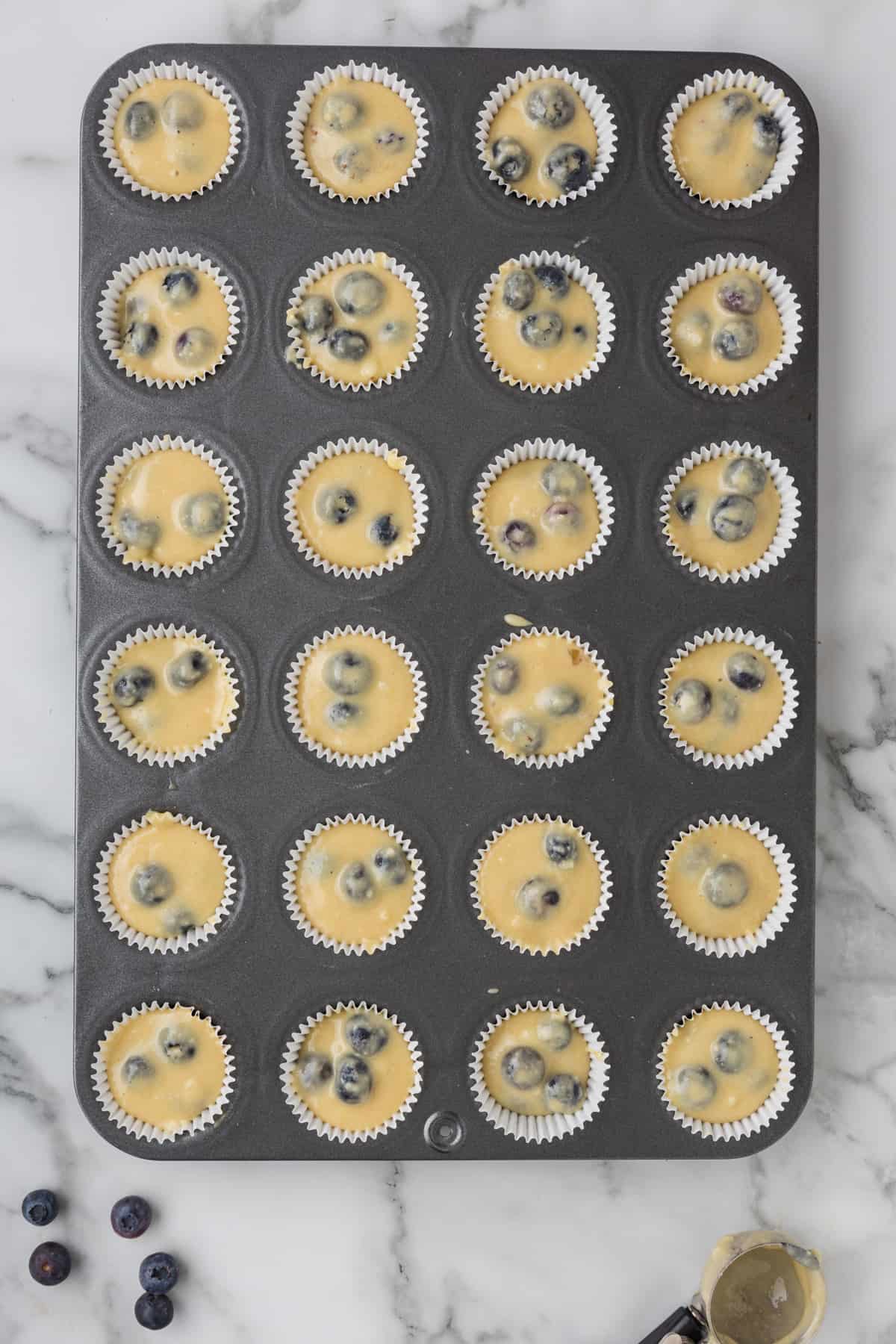 Blueberry muffins in a muffin tin.