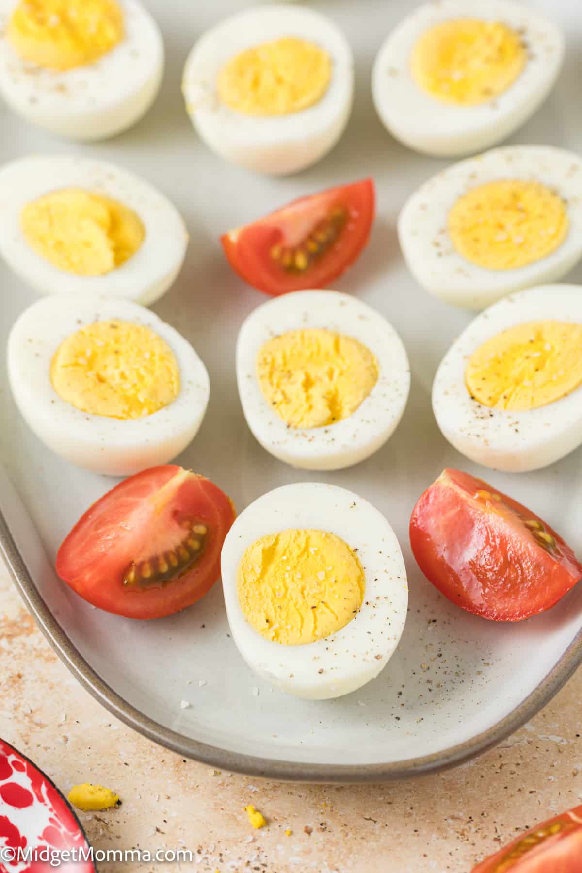 plate with cooked eggs and slices of tomatoes 