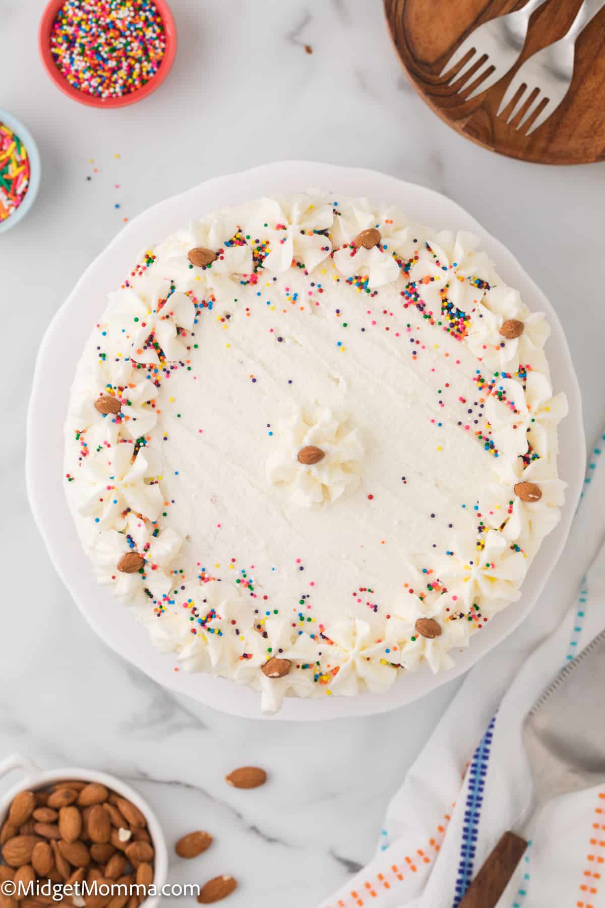 overhead view of a homemade vanilla cake on a cake platter