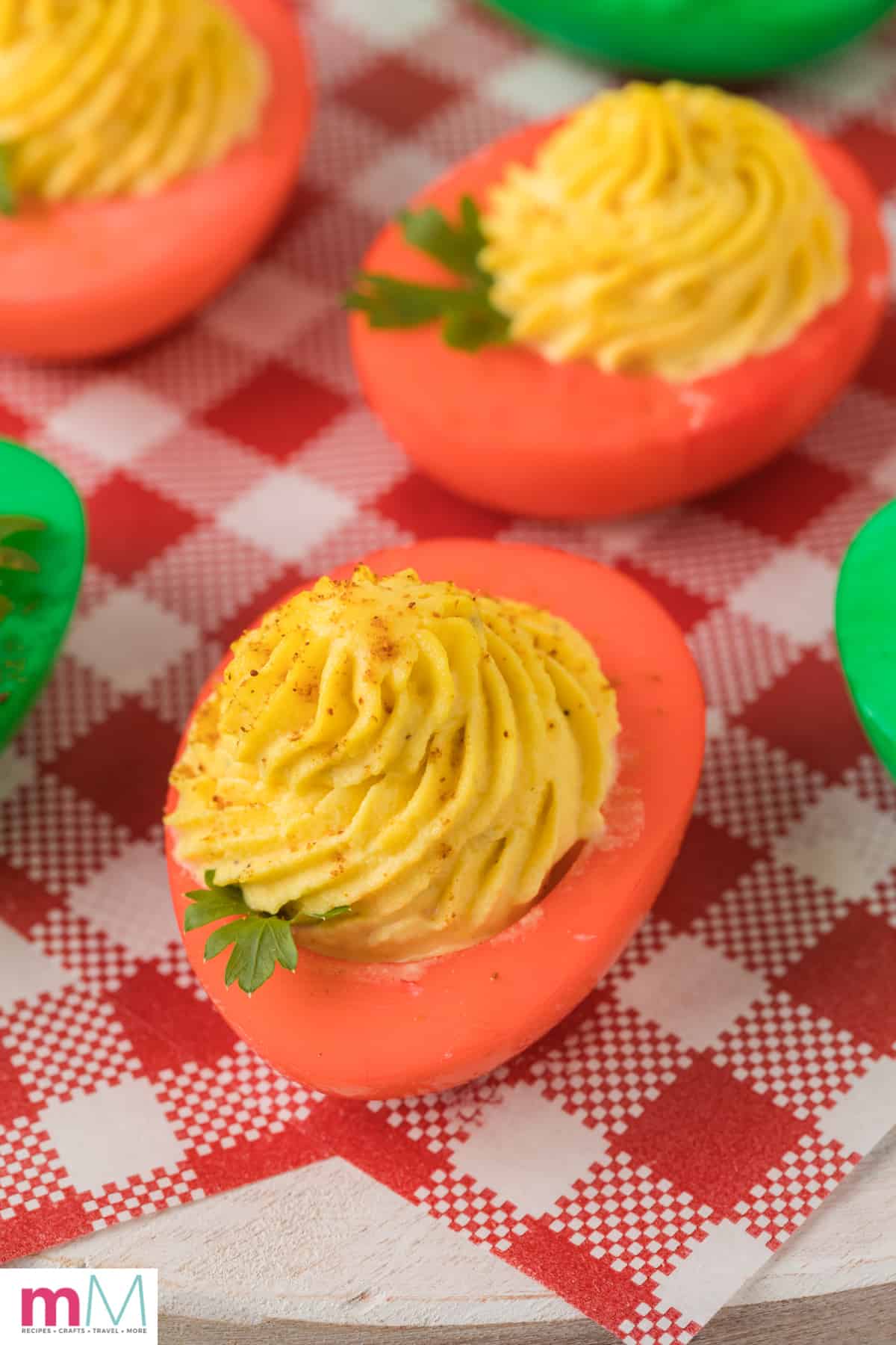 close up photo of red colored deviled egg with deviled egg filling