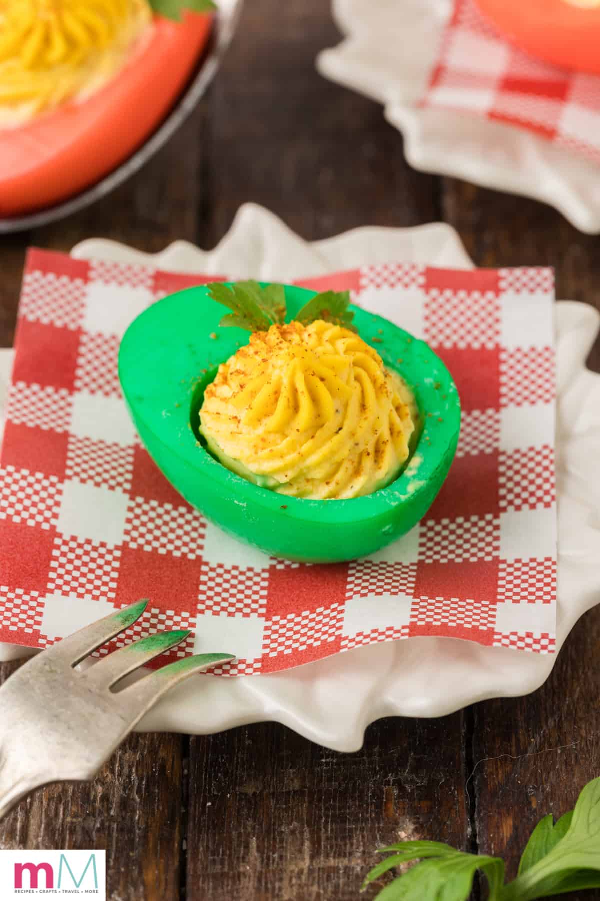 green colored deviled egg on a plate