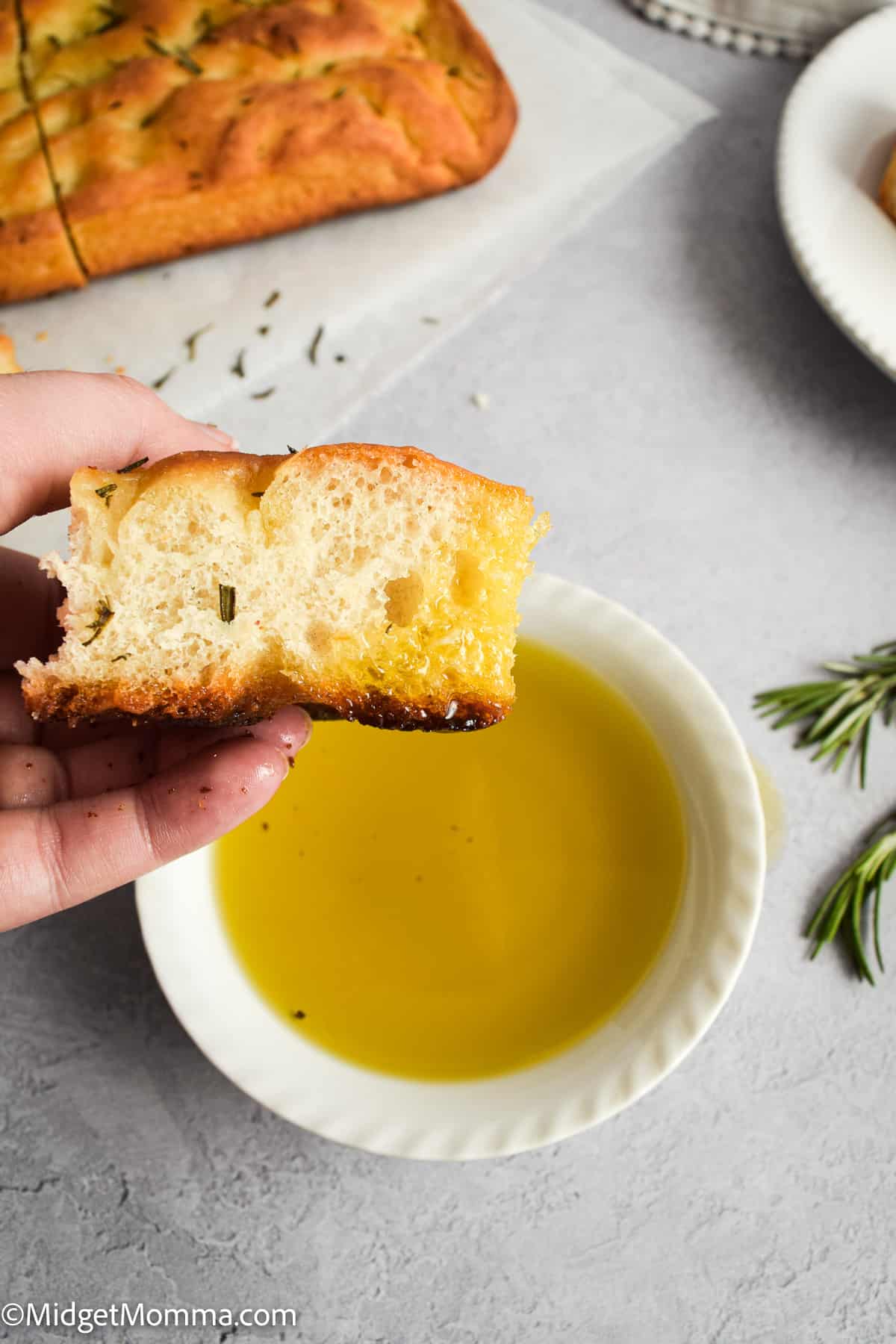Easy Focaccia Bread dipped in olive oil