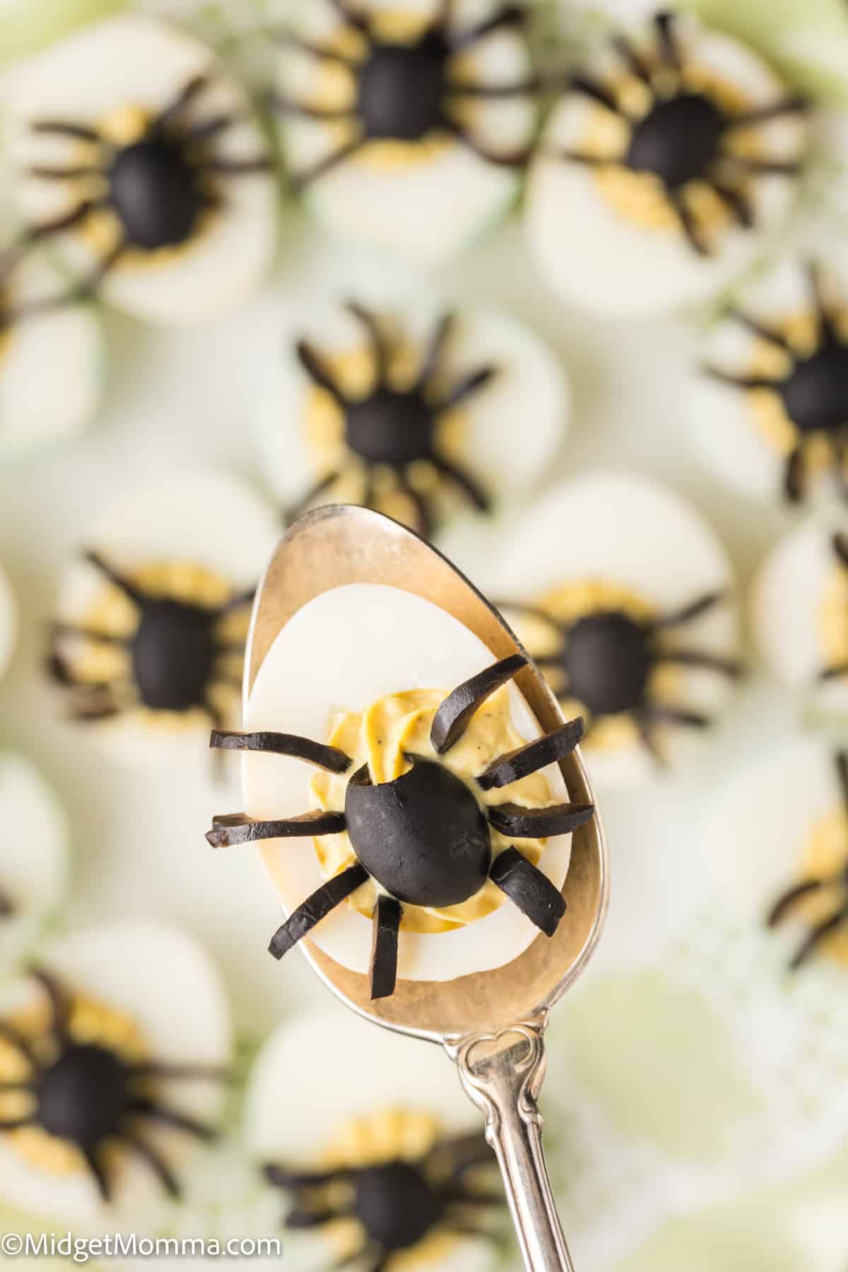 close up of halloween deviled egg on a spoon