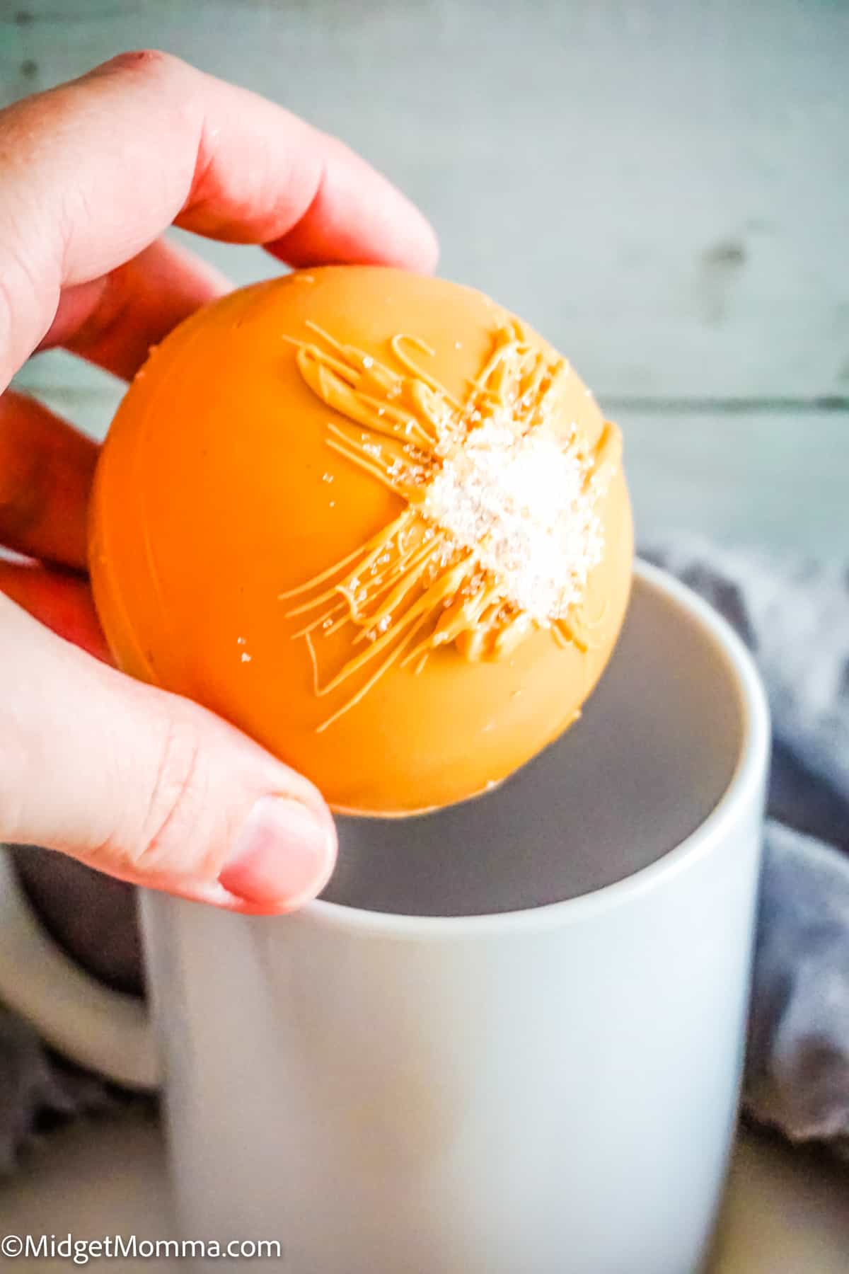 Rich and creamy salted caramel hot chocolate bomb in a mug