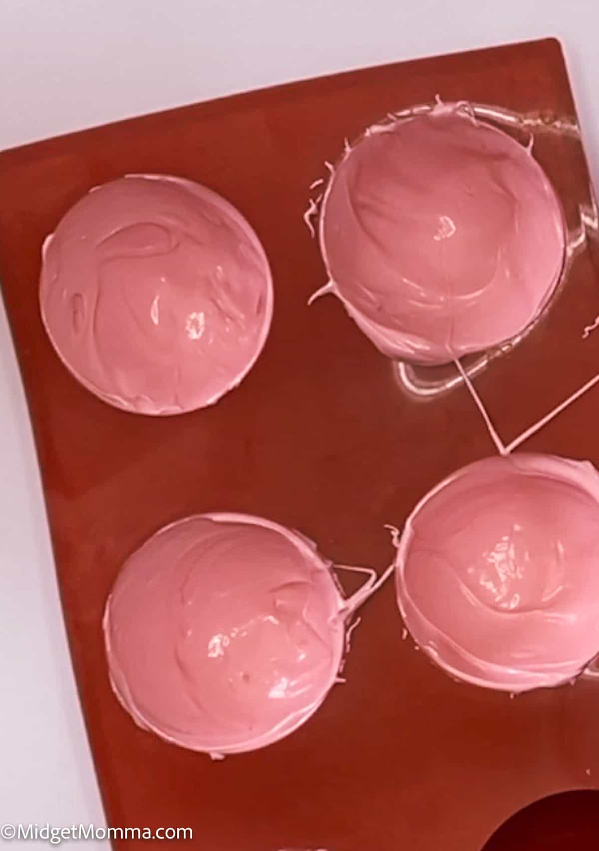 melted strawberry candy melts in a sphere mold
