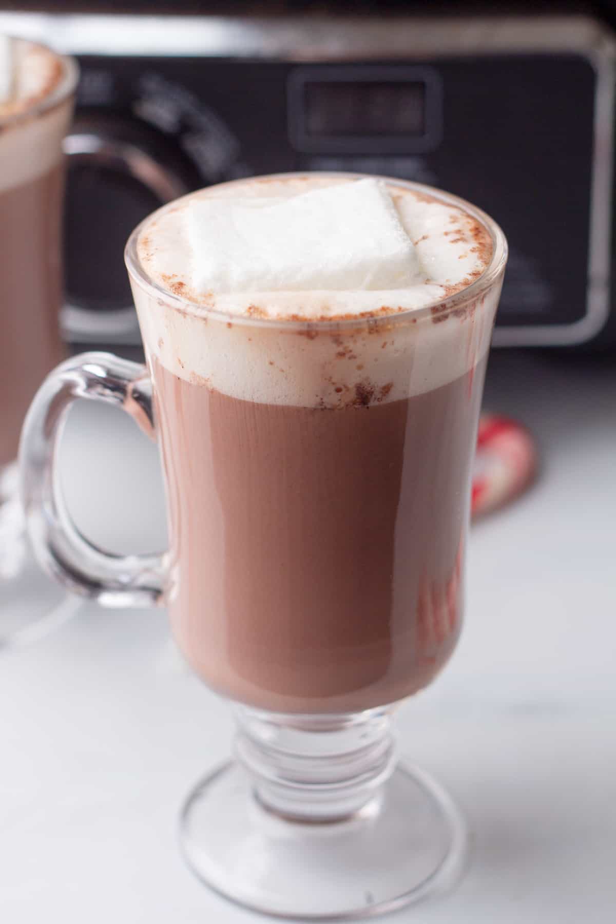 Two glasses of hot chocolate with marshmallows on top.