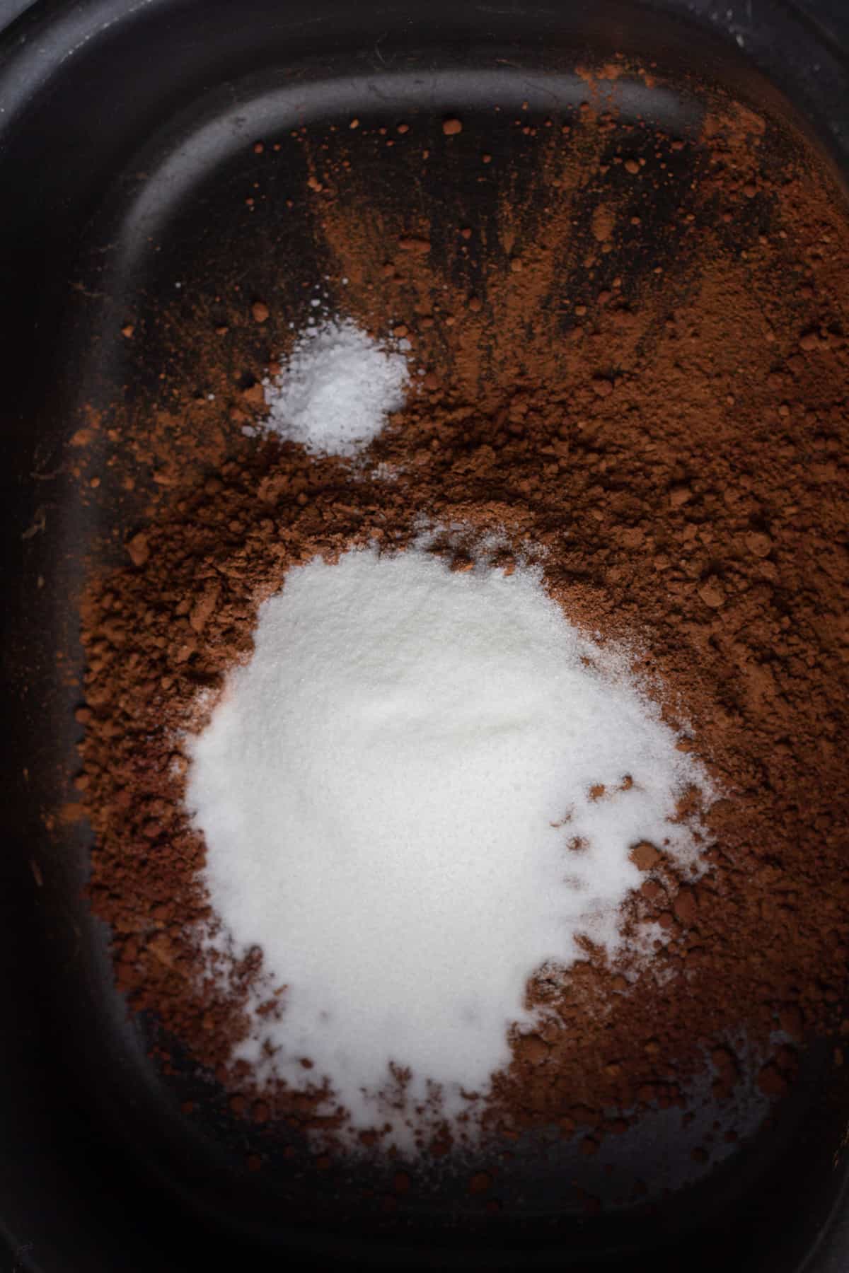 Sugar and cocoa powder in a slow cooker.