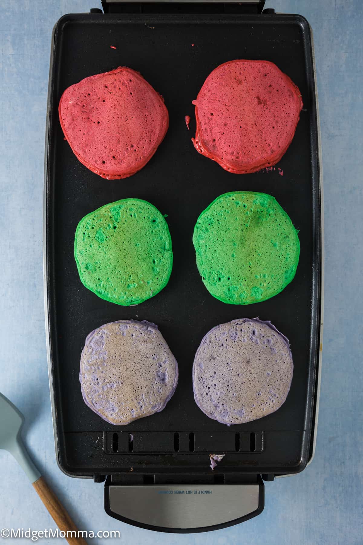 Rainbow pancakes on a griddle.