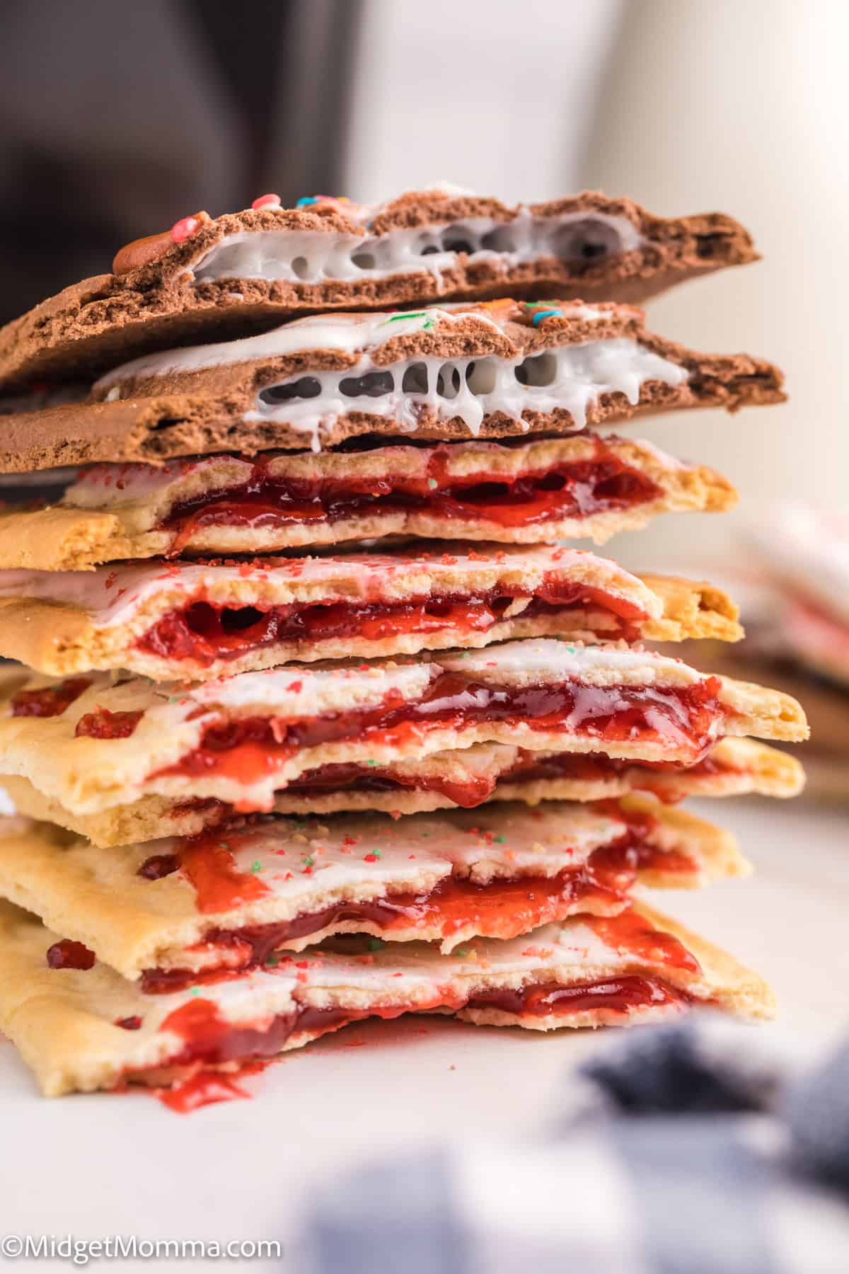 A stack of split Pop-Tarts with various fillings, including chocolate and fruit flavors, showing their textured interiors.